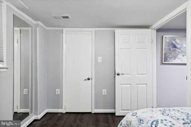 bedroom featuring dark wood-style floors, baseboards, and visible vents