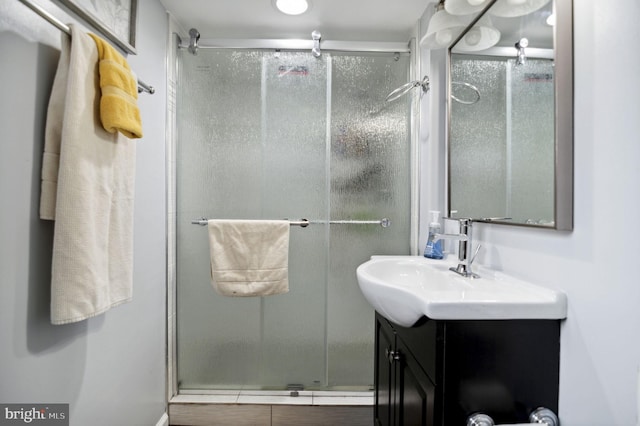 bathroom featuring a stall shower and vanity