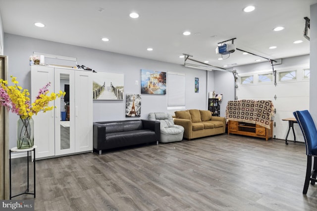 interior space with a garage, recessed lighting, and wood finished floors