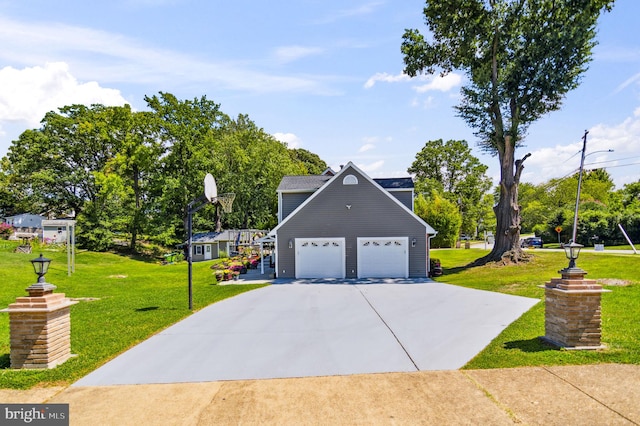 exterior space with driveway, an attached garage, and a yard