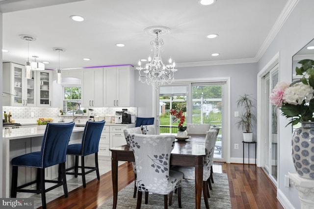 dining space featuring recessed lighting, crown molding, baseboards, dark wood finished floors, and an inviting chandelier