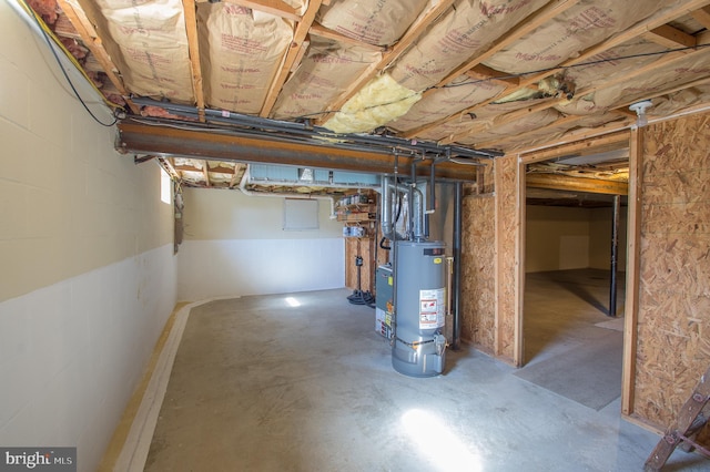 unfinished basement featuring gas water heater