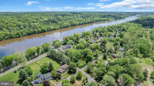 bird's eye view of a heavily wooded area and a nearby body of water