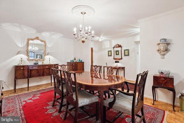 dining space featuring baseboards, ornamental molding, and a notable chandelier