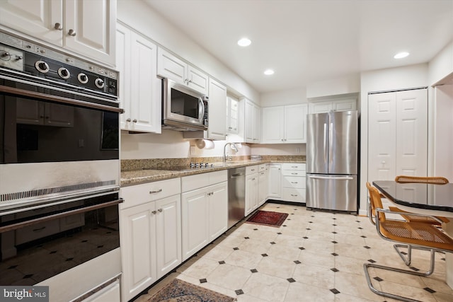 kitchen featuring appliances with stainless steel finishes, recessed lighting, and white cabinets