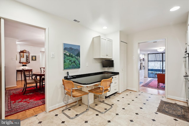 interior space with baseboards, recessed lighting, visible vents, and white cabinetry