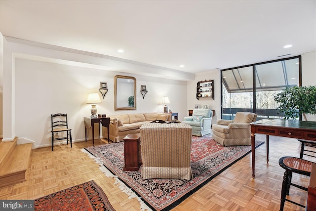 living room featuring ornamental molding, recessed lighting, and baseboards