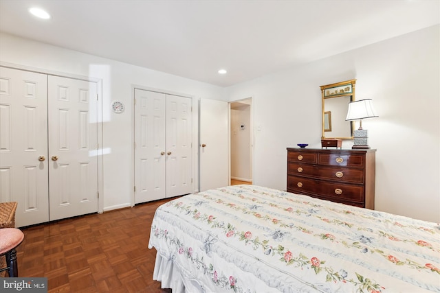 bedroom featuring two closets and recessed lighting