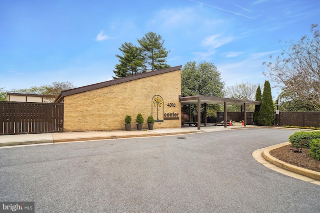 view of home's exterior featuring fence and brick siding