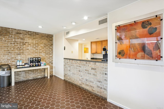 kitchen featuring brick wall, visible vents, and recessed lighting