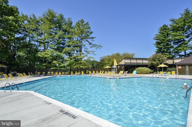 community pool featuring a patio area and fence