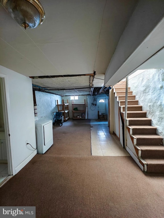 interior space with stairs, carpet flooring, and washer / dryer