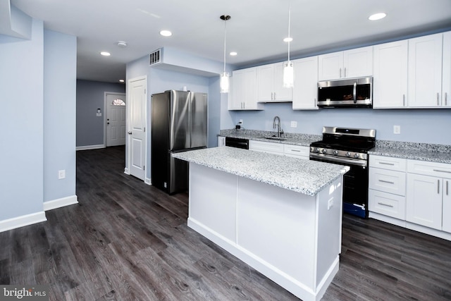 kitchen with dark wood-type flooring, white cabinets, a center island, and stainless steel appliances