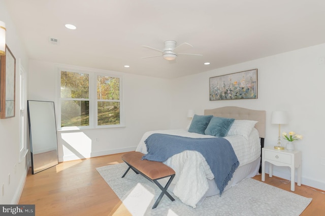 bedroom with recessed lighting, visible vents, ceiling fan, wood finished floors, and baseboards