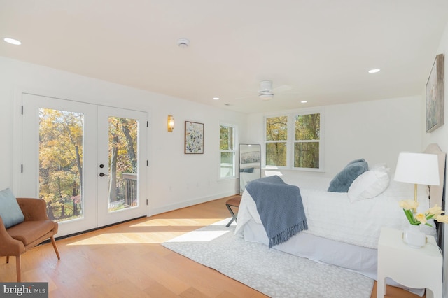 bedroom with access to outside, french doors, and wood finished floors