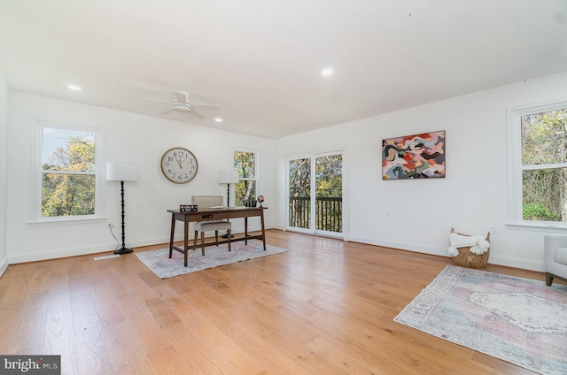 office space featuring light wood-type flooring, baseboards, a ceiling fan, and recessed lighting