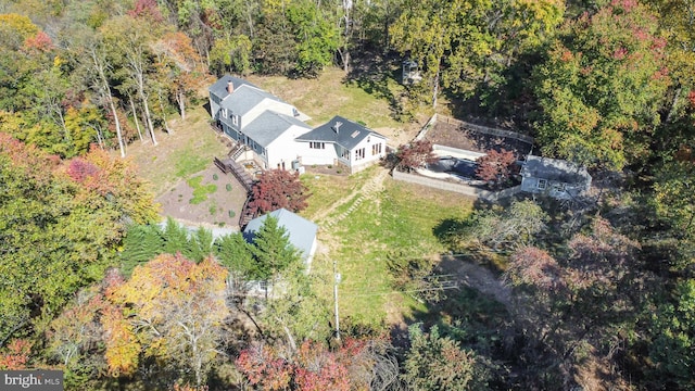 drone / aerial view featuring a wooded view