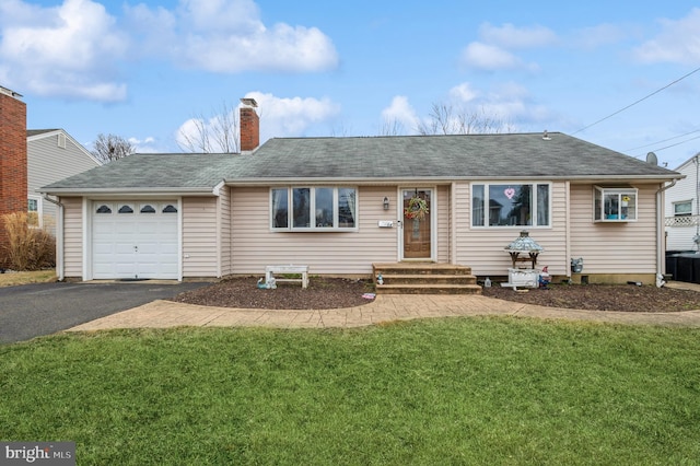 ranch-style home with driveway, a shingled roof, a chimney, an attached garage, and a front yard