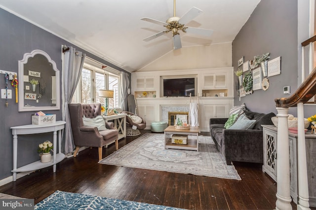 living room featuring a ceiling fan, lofted ceiling, wood-type flooring, and a fireplace