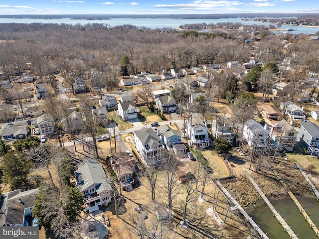 drone / aerial view with a water view and a residential view