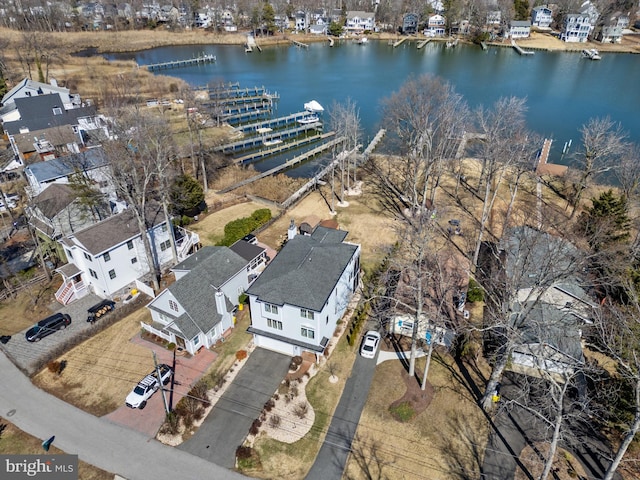 drone / aerial view with a water view and a residential view