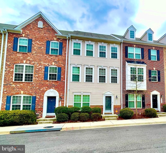 view of property with brick siding