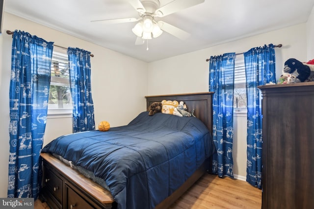 bedroom with wood finished floors and a ceiling fan