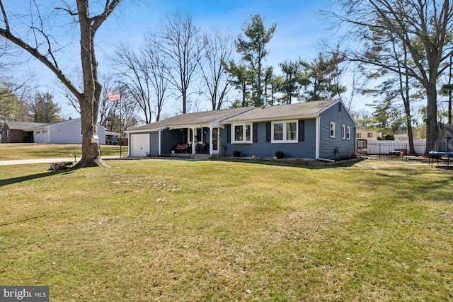 ranch-style home featuring a garage, a trampoline, a front yard, and fence