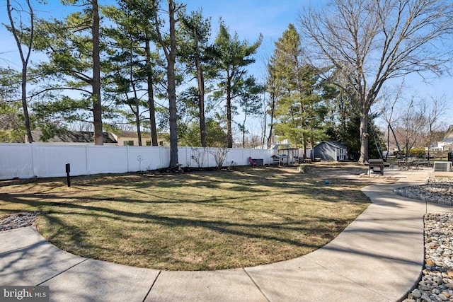 view of yard with a fenced backyard and an outdoor structure