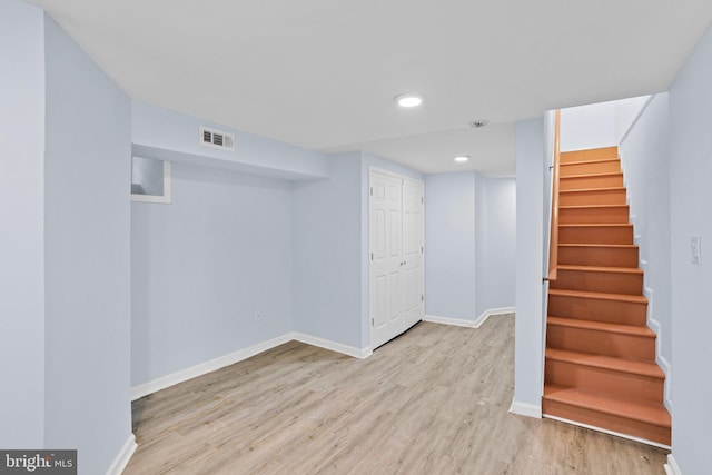 finished basement with recessed lighting, visible vents, wood finished floors, baseboards, and stairs