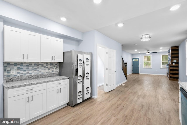 kitchen featuring tasteful backsplash, light wood-style floors, white cabinets, and stainless steel fridge with ice dispenser