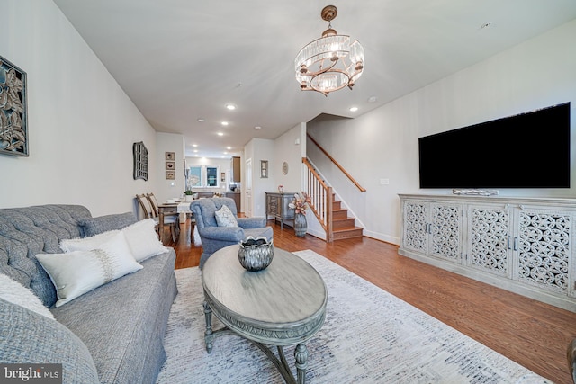 living area with a chandelier, stairway, recessed lighting, and wood finished floors