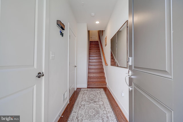 doorway to outside featuring stairs, dark wood-type flooring, and baseboards