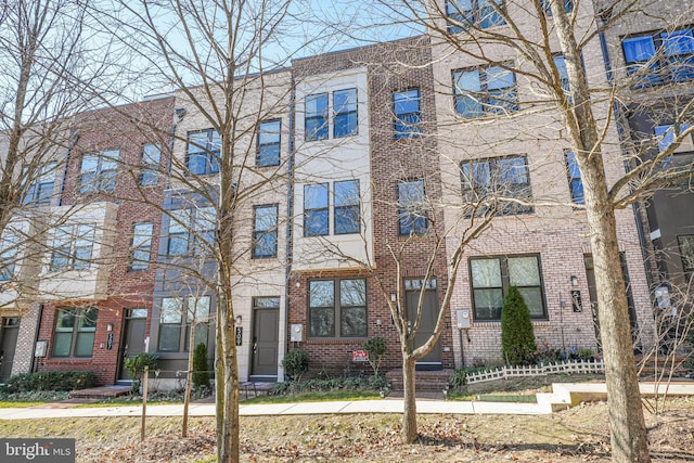 townhome / multi-family property with brick siding