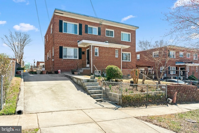 view of front facade with fence and brick siding