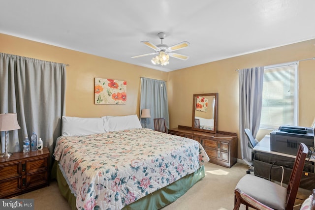 bedroom featuring light colored carpet and ceiling fan