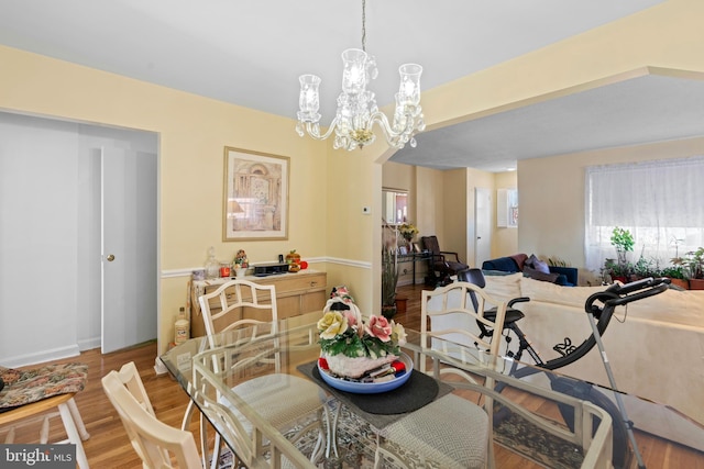 dining room featuring light wood-style floors and a chandelier