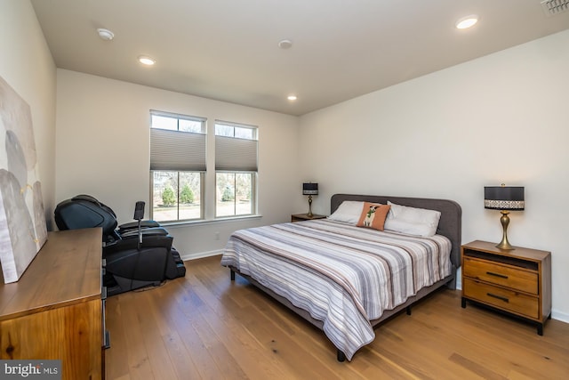 bedroom with hardwood / wood-style flooring, baseboards, visible vents, and recessed lighting