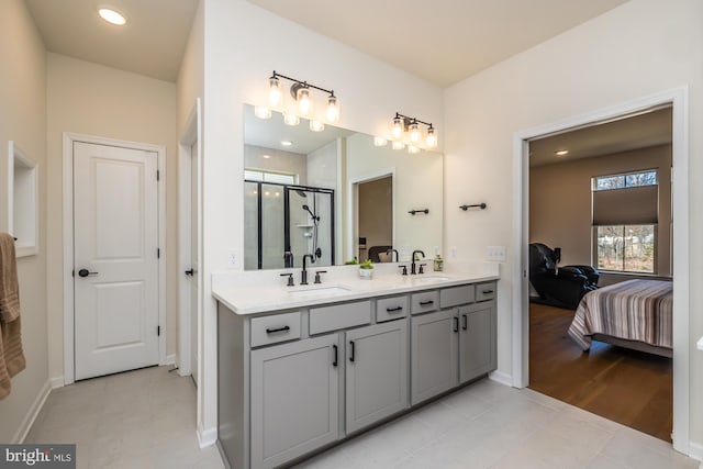 ensuite bathroom with double vanity, a sink, a shower stall, and ensuite bathroom