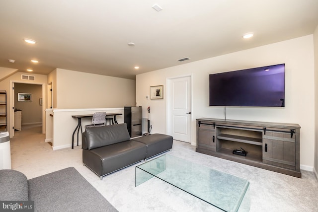 living room with visible vents, carpet flooring, and recessed lighting