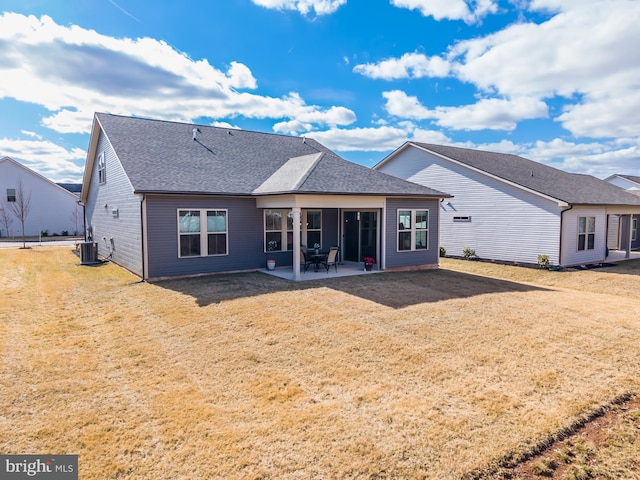 back of house featuring a patio area, a shingled roof, central AC, and a yard