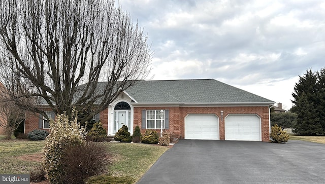 view of front of house with an attached garage, roof with shingles, aphalt driveway, and brick siding