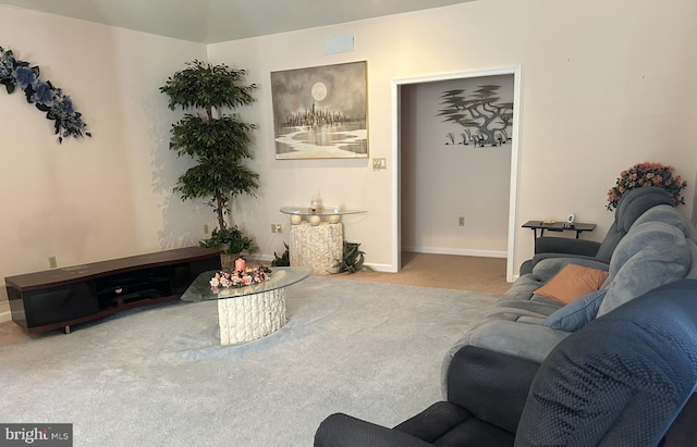 living room featuring carpet, visible vents, and baseboards