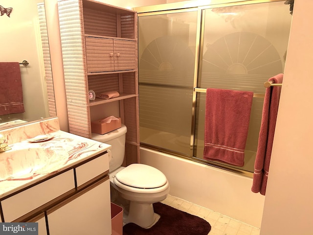 bathroom with toilet, combined bath / shower with glass door, and vanity