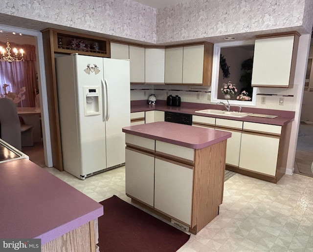 kitchen featuring a kitchen island, light floors, white fridge with ice dispenser, a chandelier, and a sink