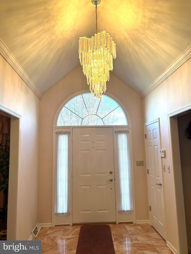 entrance foyer with lofted ceiling, visible vents, an inviting chandelier, ornamental molding, and baseboards