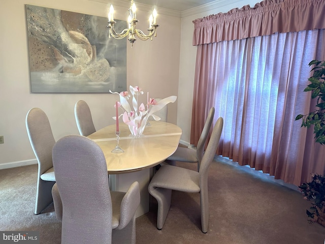 dining area with carpet floors, crown molding, baseboards, and an inviting chandelier