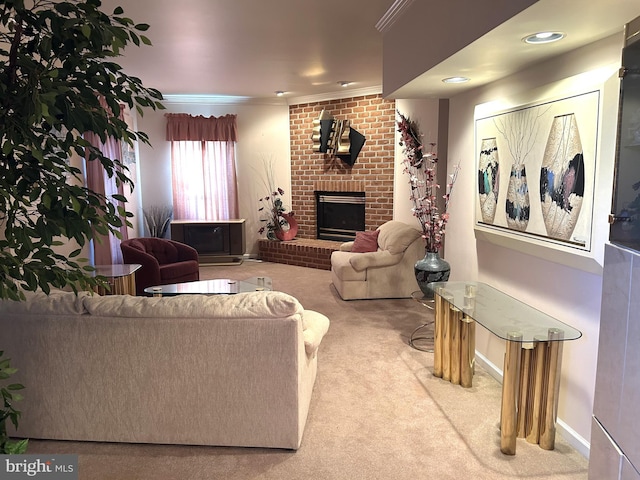 living room with baseboards, carpet floors, a fireplace, and crown molding