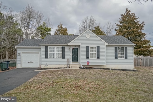 ranch-style home with aphalt driveway, a shingled roof, an attached garage, a front yard, and fence