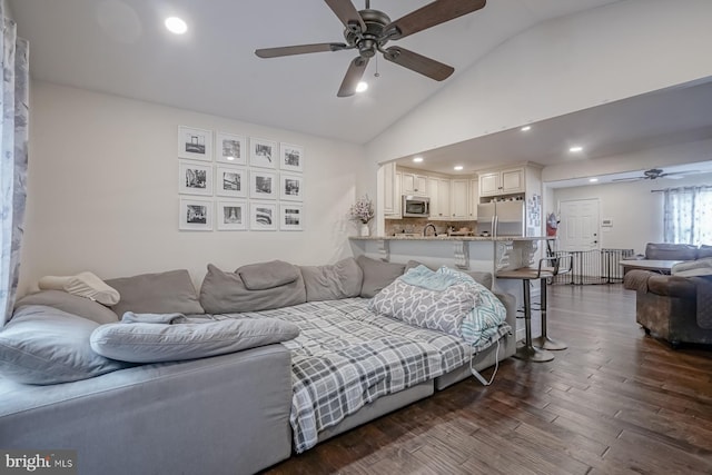 living area with lofted ceiling, dark wood finished floors, a ceiling fan, and recessed lighting